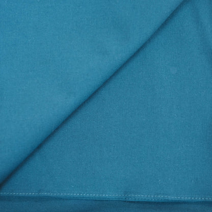 Teal furoshiki fabric with a diagonal seam and stitching detail