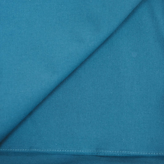 Teal furoshiki fabric with a diagonal seam and stitching detail