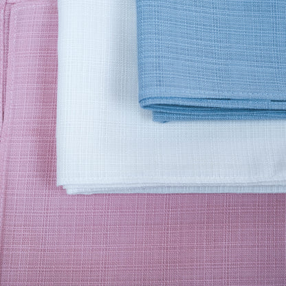 Close-up of pink, white, and blue textured fabric swatches.
