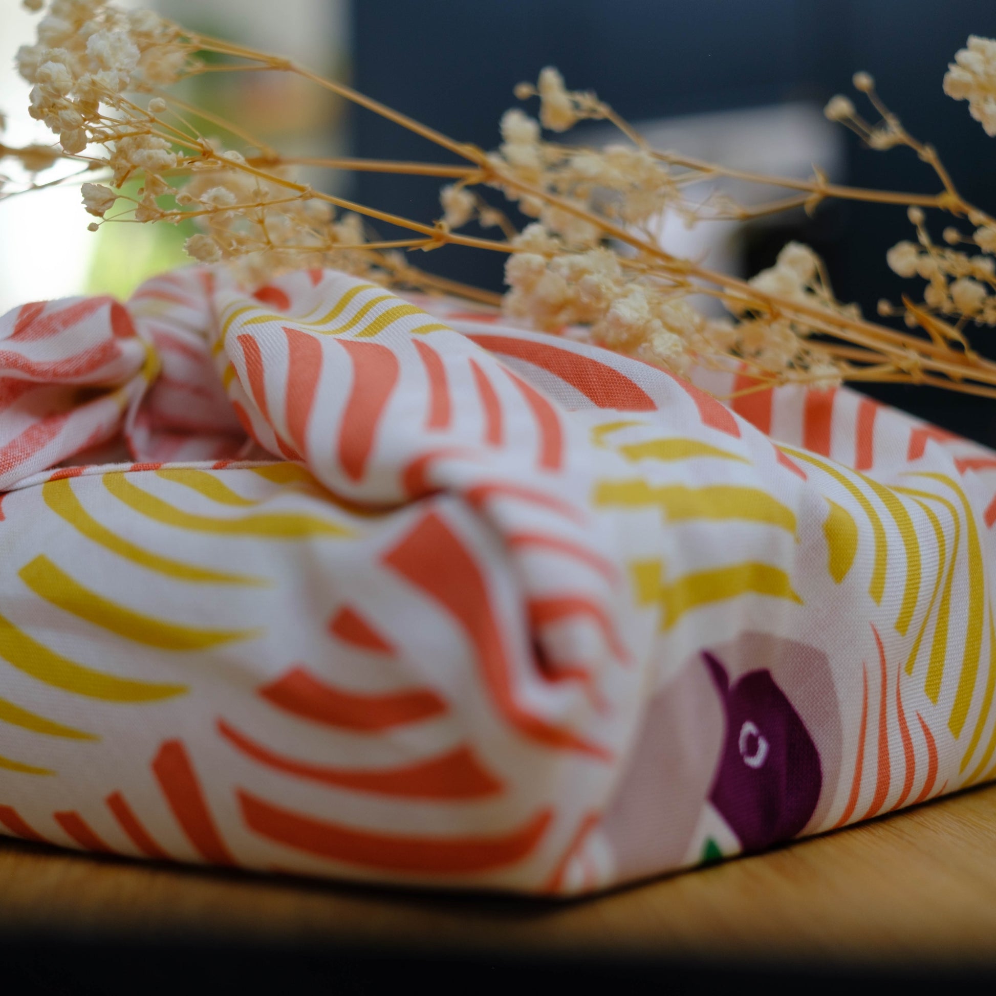 Colorful fabric with abstract patterns on a wooden surface
