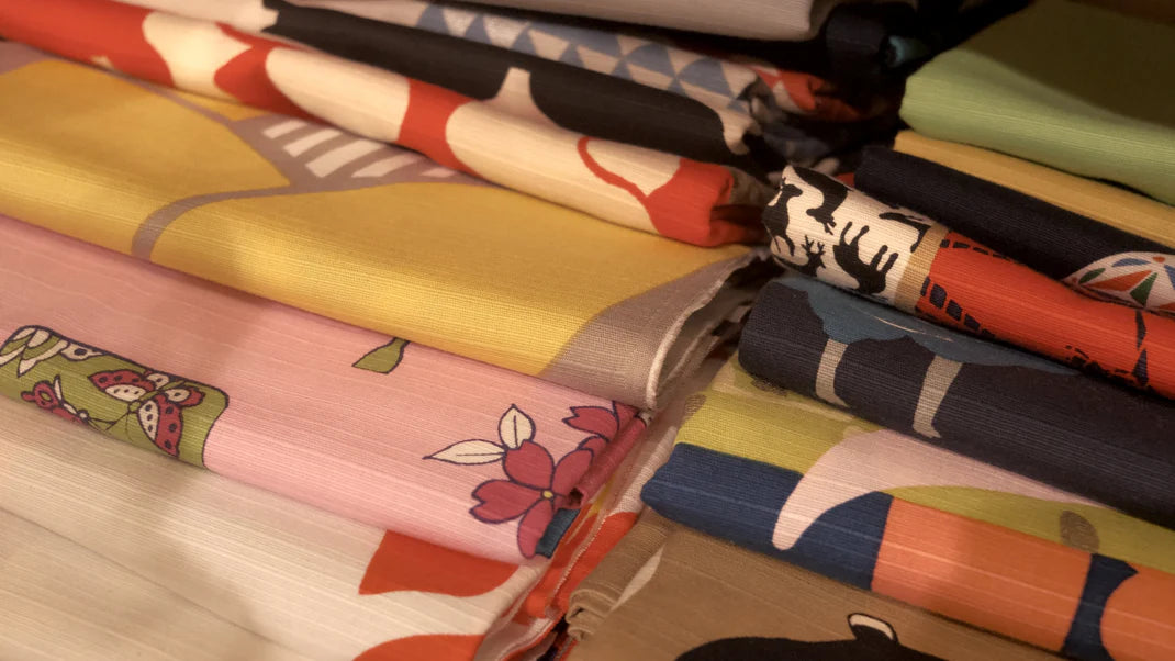 Collection of colorful fabric swatches arranged on a wooden surface
