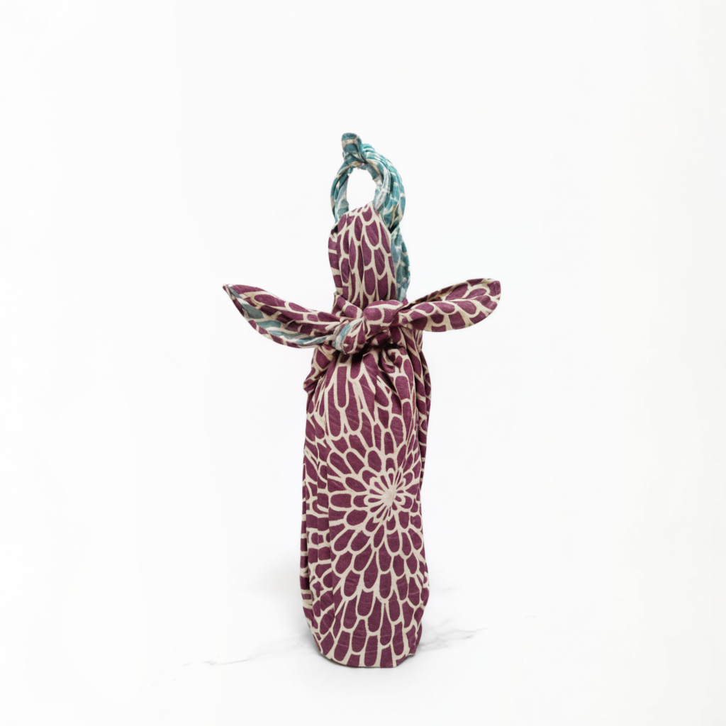 Purple patterned bottle bag with a handle on a white background
