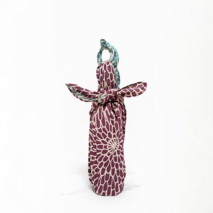 Purple patterned bottle bag with a handle on a white background